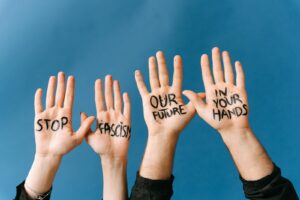Four hands with messages against fascism for an activism campaign.